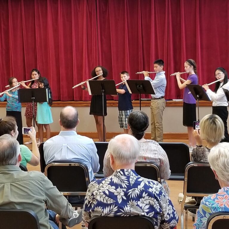 students in grades 5-12 play together in full ensemble for the final concert